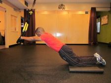 trx kneeling plank roll out